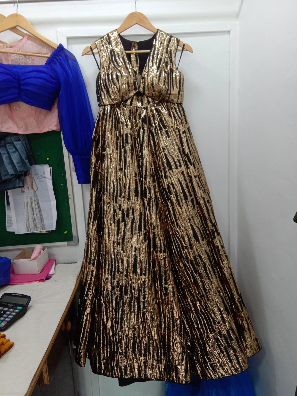 A gold and black brocade evening gown finished by Fusion Tailoring