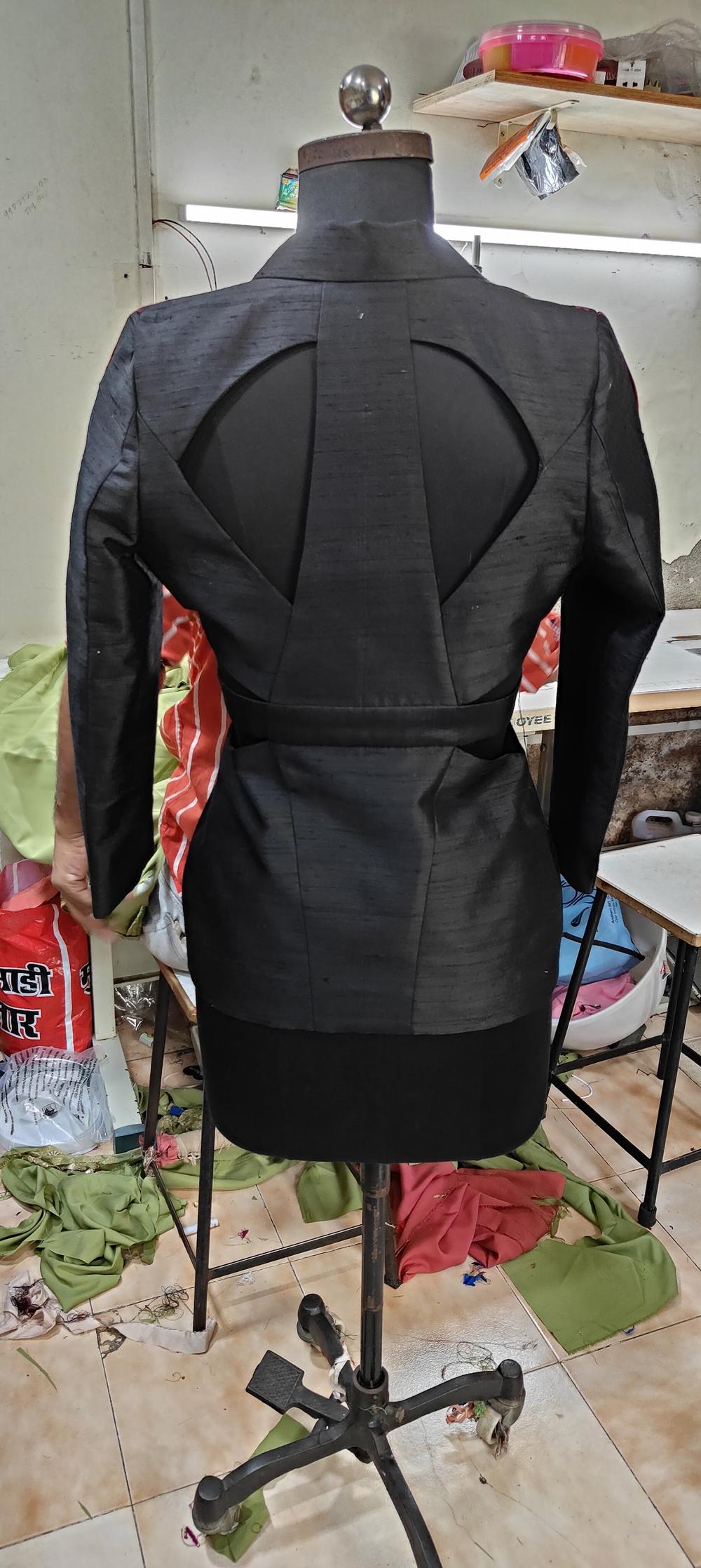 The structured back panel of a tailored jacket, showing the construction detail